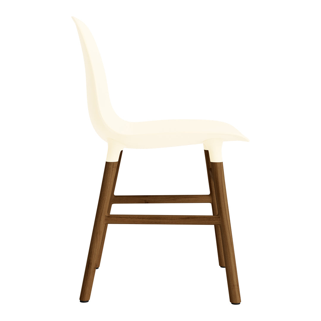 Side view of a cream chair with a rich brown wooden base, featuring a smooth, minimalist design.