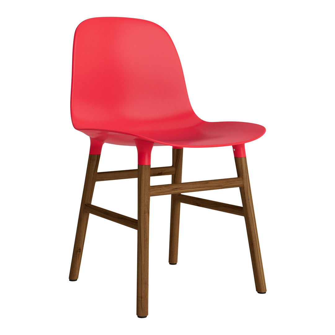 Red molded plastic chair with wooden legs, featuring a sleek, modern design. Perfect for vibrant interiors.