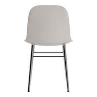 Gray molded chair with a smooth surface and sleek chrome legs, ideal for modern decor.