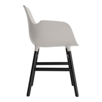 Gray ergonomic chair with contrasting black wooden legs. Smooth, minimalist design for modern decor.