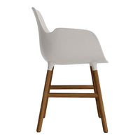 White armchair with a smooth finish and light wood legs, featuring a minimalist design.