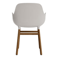 White armchair with a smooth finish and natural wood legs, showcasing a minimalist design and elegant color contrast.
