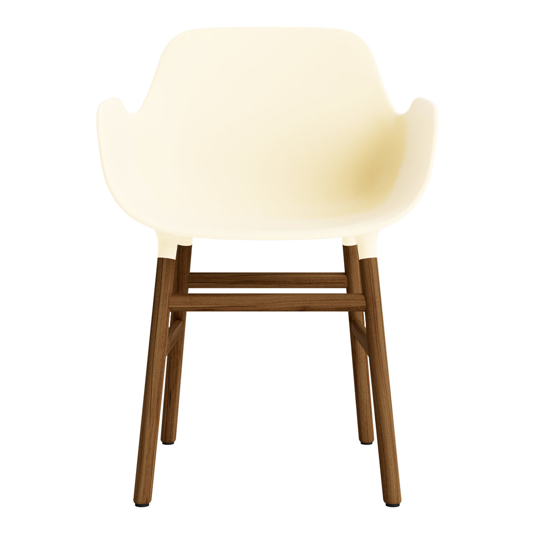Cream-colored chair with smooth, curved design and contrasting dark wooden legs. Modern, minimalistic style.