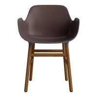 Brown molded chair with smooth finish and wooden legs, showcasing a modern and minimalist design.