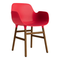 Bright red chair with smooth surface and wooden legs, featuring a modern design and sleek silhouette.