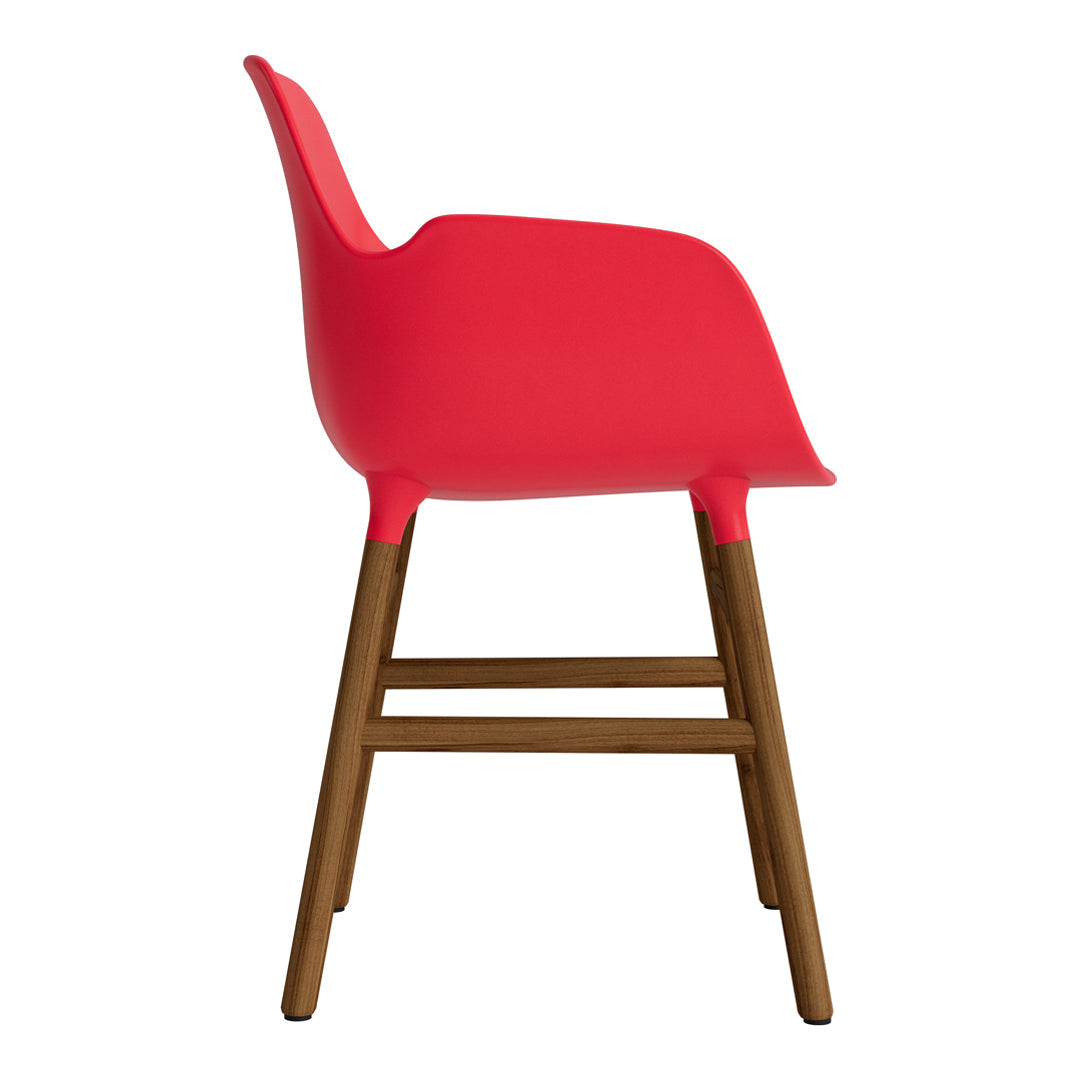 Bright red chair with smooth curves and a wooden base, perfect for modern decor.