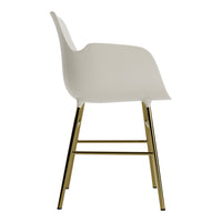 White chair with a smooth, modern design and shiny gold legs, showcasing a stylish and sleek contrast.