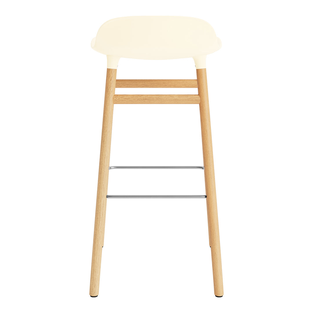 Cream-colored seat with light wooden legs and a silver footrest, featuring a minimalist design.