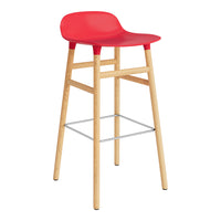 Bright red bar stool with a smooth seat and natural wood legs, featuring a minimalist design and modern aesthetic.