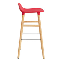 Red bar stool with a sleek curved seat and natural wooden legs, featuring a minimalist design.