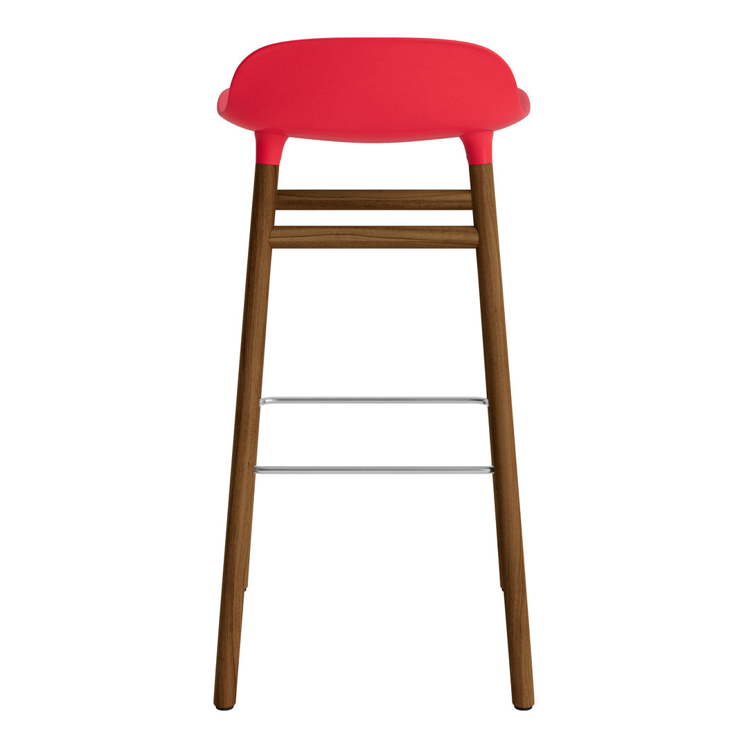 Red upholstered bar stool with a sleek wooden base and silver footrest. Modern design, vibrant color pops.