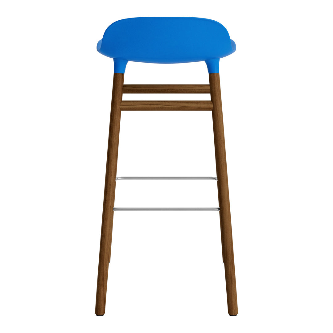 Blue plastic seat with natural wood legs and silver footrest, modern design. Perfect for stylish interiors.