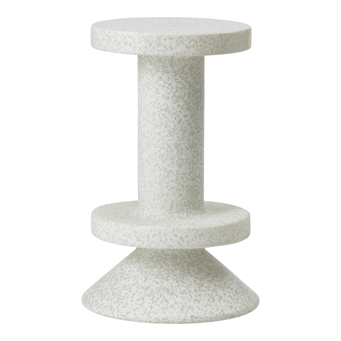 Light gray textured table with a speckled finish, featuring a circular top and conical base design.