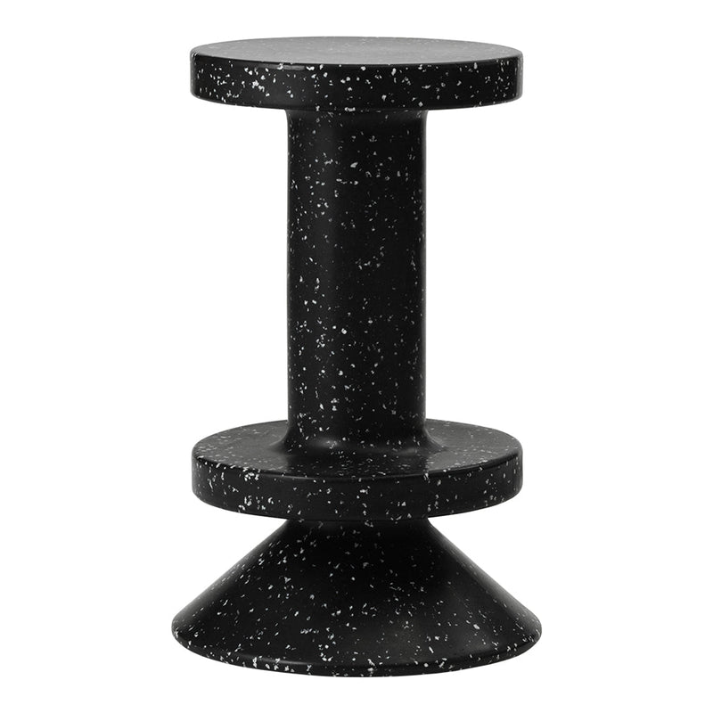 Black stool with a speckled white pattern, featuring a modern design with a circular top and conical base.