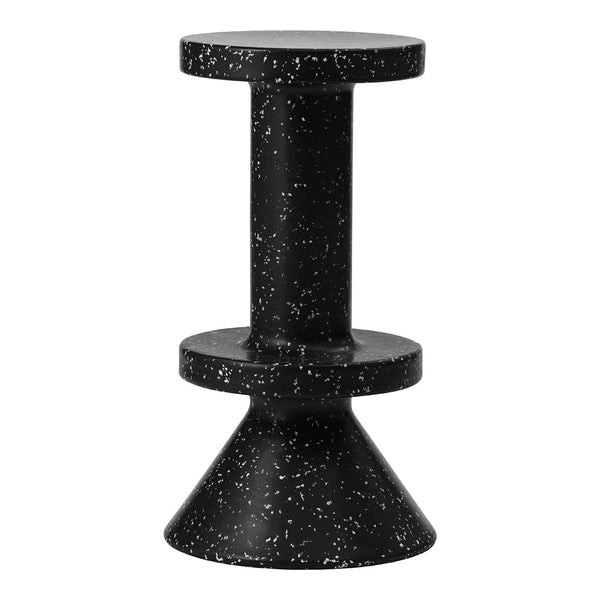 Black speckled accent table with a cylindrical top and conical base, featuring a modern and sleek design.