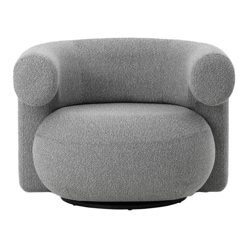 Soft gray upholstered chair with rounded shapes and textured fabric, perfect for modern decor.