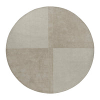 Round rug featuring a soft beige color with a subtle patchwork pattern in varying textures. Ideal for any modern space.