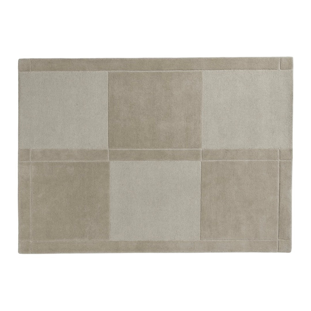 Beige geometric rug featuring soft, muted tones and a patchwork design. Perfect for modern decor.