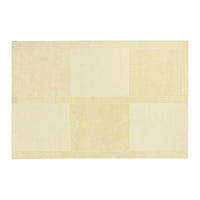 beige patchwork rug with soft texture and subtle tonal variations in shades of cream and off-white.