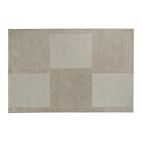 Beige rectangular rug with a patchwork design in varying shades of cream and light taupe. Soft, textured finish.