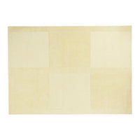 Beige rug featuring a subtle patchwork pattern with varying textures and shades of cream. Ideal for modern decor.