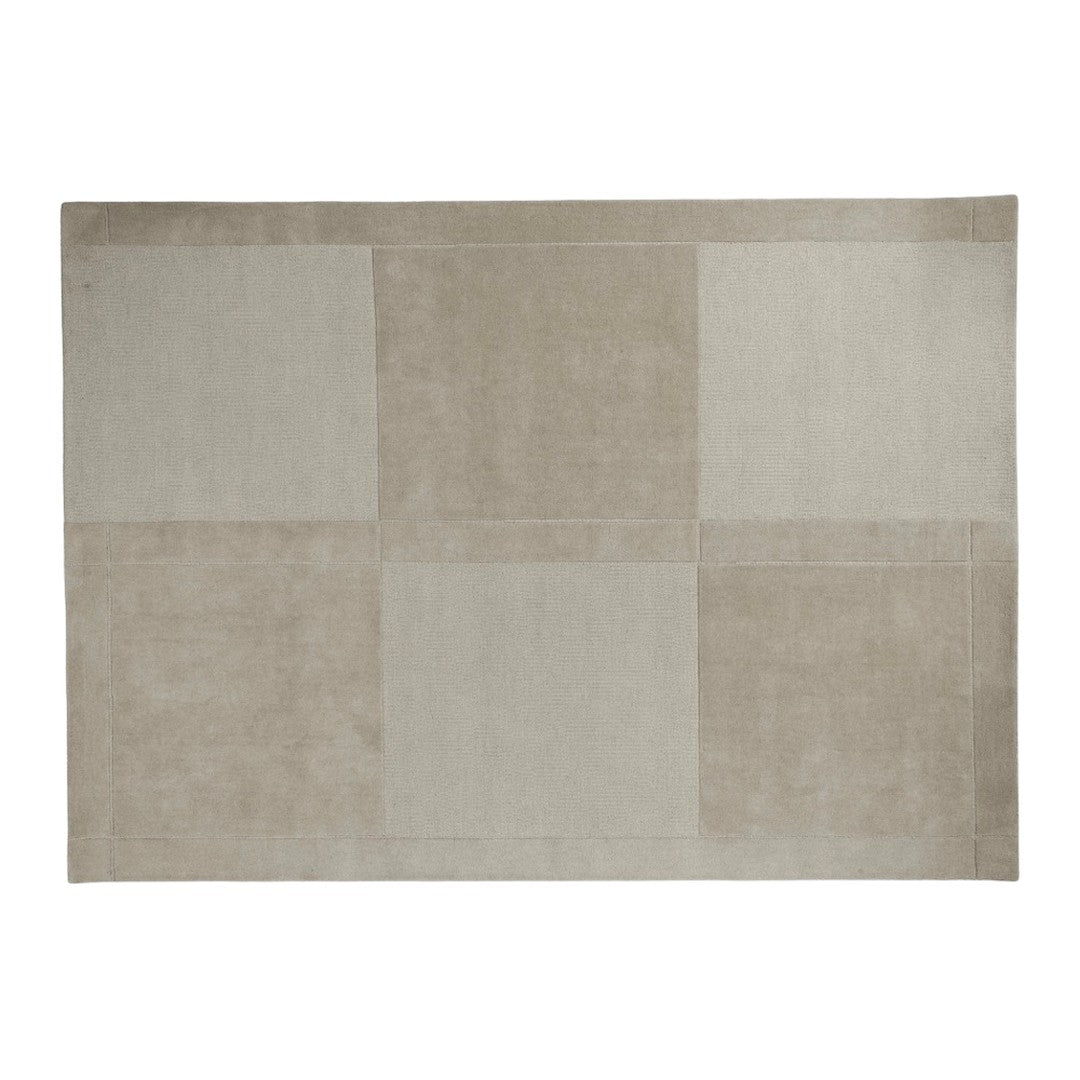 Beige geometric rug with varying shades and textures, featuring a modern patchwork design.