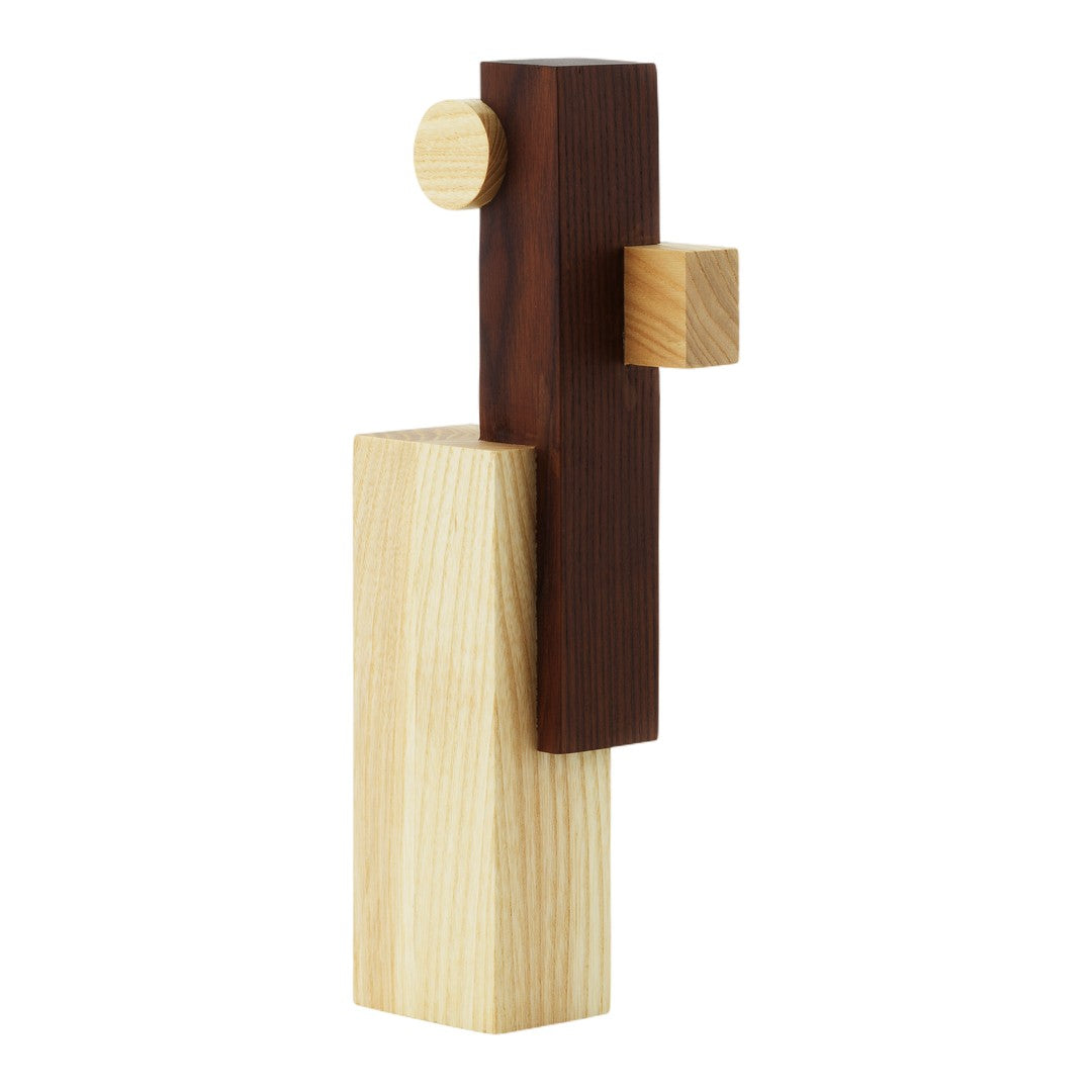 Wooden sculpture featuring natural light and dark wood tones with smooth geometric shapes and clean lines.