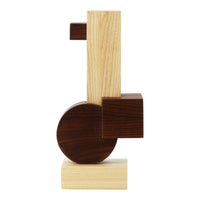 Abstract wooden sculpture in light oak, dark walnut, and natural finishes with geometric shapes and clean lines.