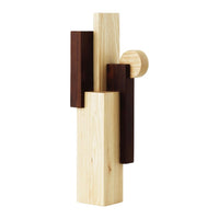 Abstract wooden sculpture featuring light blonde and deep dark brown tones with geometric patterns.
