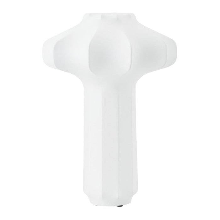 White sculptural lamp design with smooth surfaces and geometric patterns, perfect for modern decor.