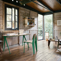 "Modern workspace featuring green accents, natural wood tones, and a mix of clean lines and rustic textures."