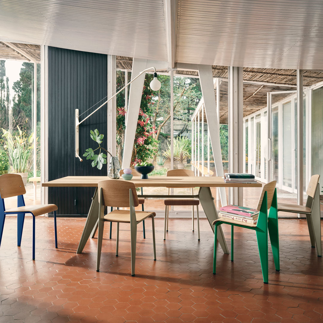 Modern dining set featuring natural wood tones, colorful accents in blue and green, and minimalist design.