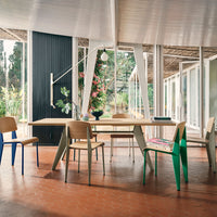 Modern dining set featuring natural wood tones, colorful accents in blue and green, and minimalist design.