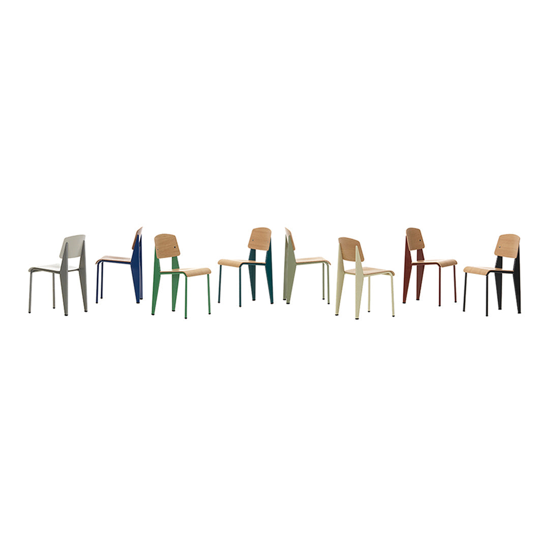 Colorful modern chairs in various shades, including green, blue, orange, gray, and natural wood tones, lined up.