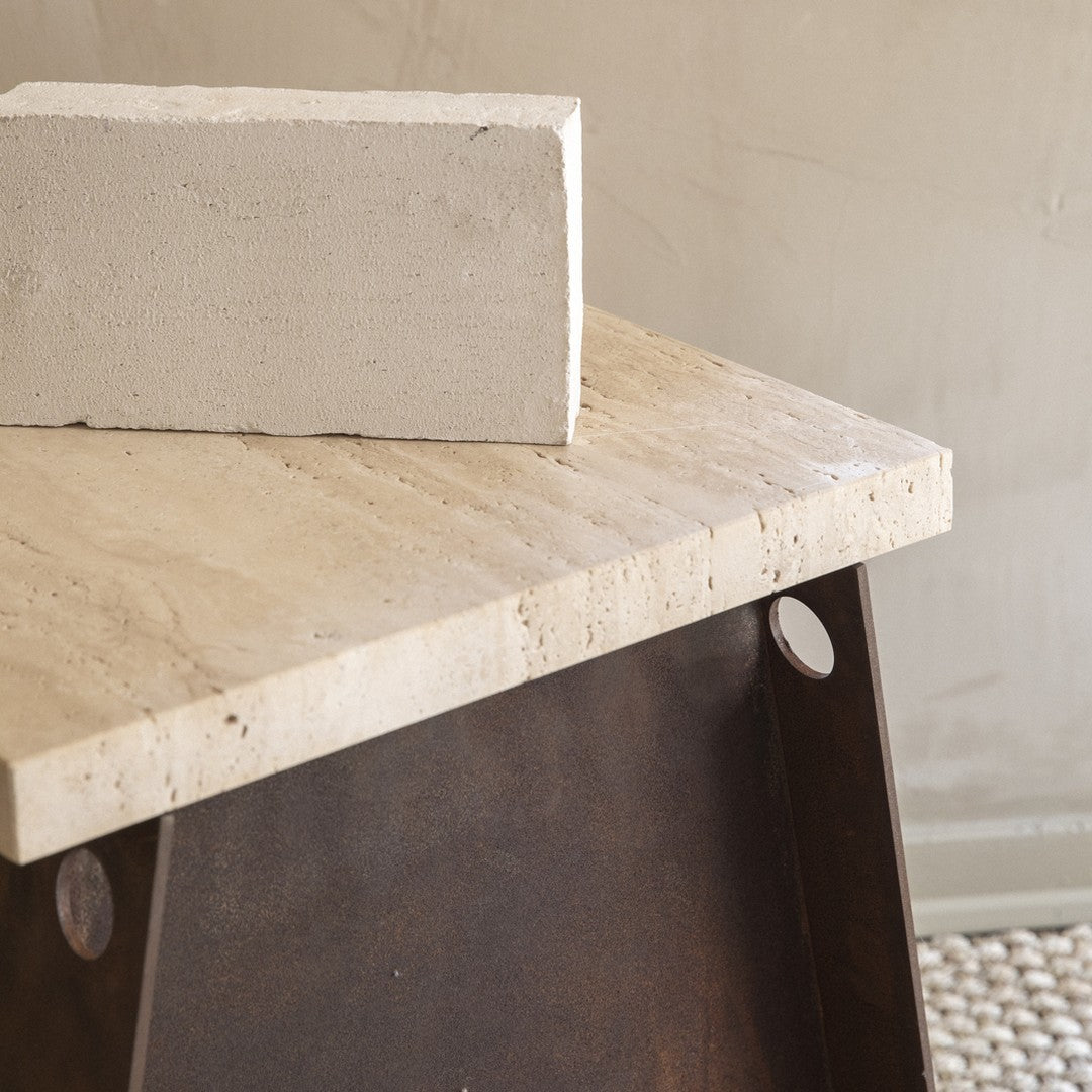 Light beige travertine tabletop with natural stone texture and rustic brown metal base, featuring smooth edges and circular cutouts.