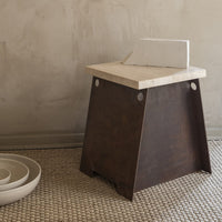 Wooden stool with a dark brown base and a light beige top, featuring clean lines and a minimalist design.