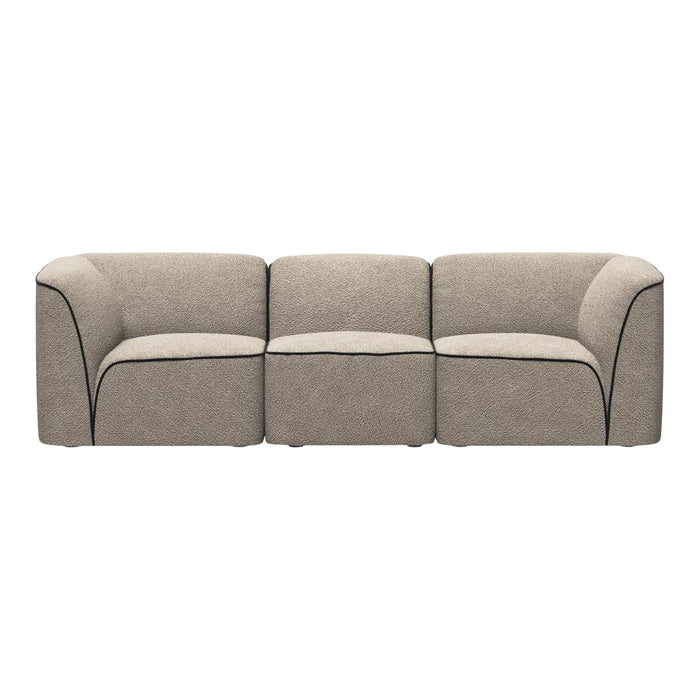 Beige three-piece sofa with contrasting black piping and smooth, rounded edges for a modern aesthetic.