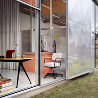Modern office chair in white fabric with a sleek, minimalist design, set against neutral tones and soft pastels.