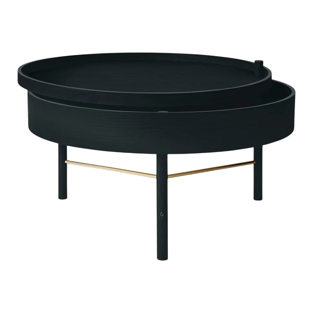 Round black coffee table with a sleek design and a contrasting gold metal support bar. Modern minimalistic style.