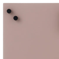 Soft pink surface with two black round knobs, creating a minimalist and modern look. Perfect for contemporary decor.