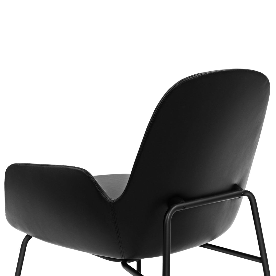 Black upholstered chair with a sleek, modern design and minimalistic metal legs. Perfect for contemporary decor.