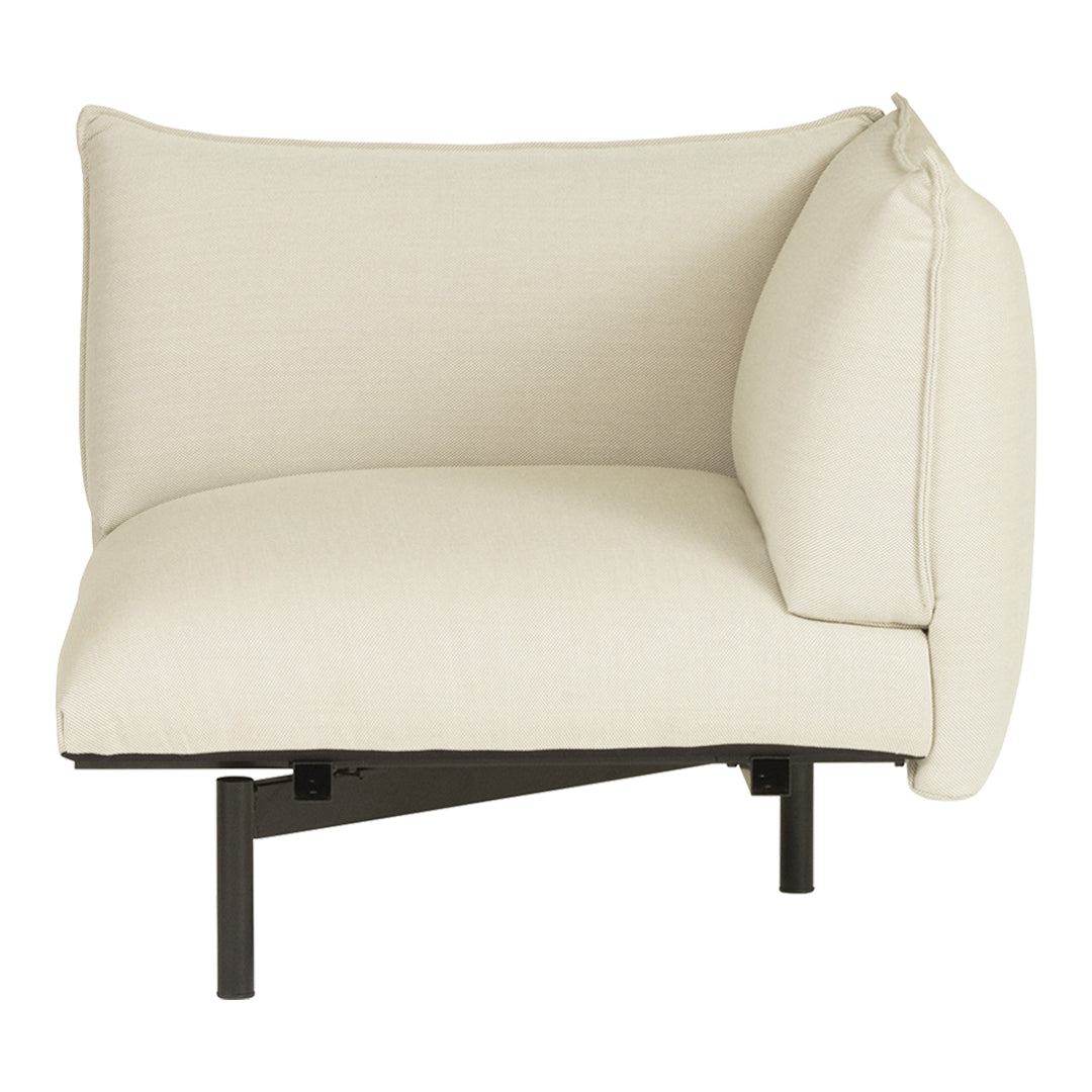 Cream-colored modern corner sofa with soft, textured fabric and sleek black metal base. Clean, minimalist design.