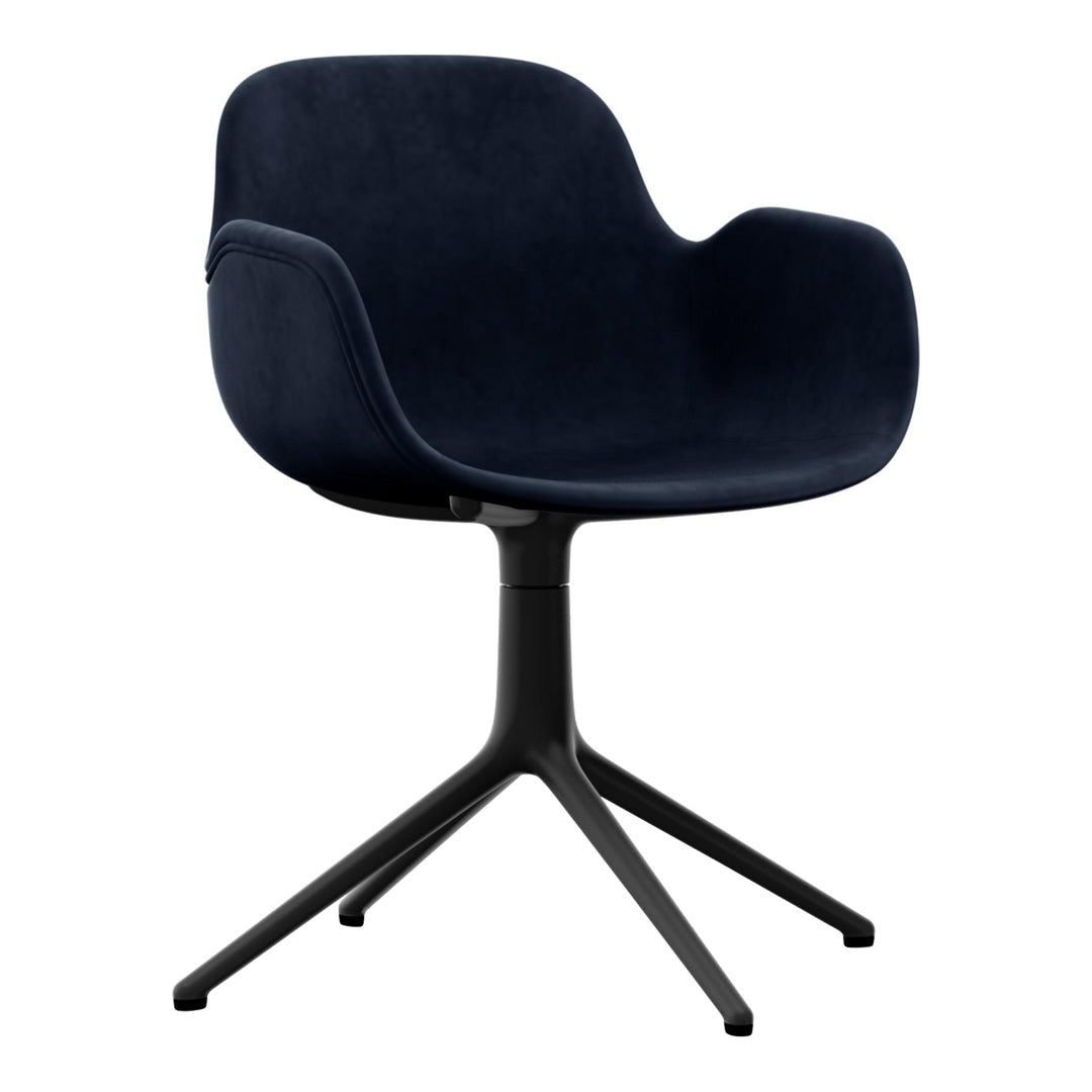 Navy velvet armchair with a sleek black base, featuring smooth, modern curves and a minimalist design.