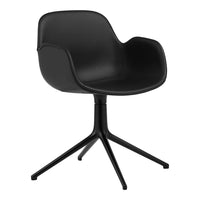 Black ergonomic chair with smooth matte finish and sleek, modern lines, sitting on a sturdy black four-legged base.