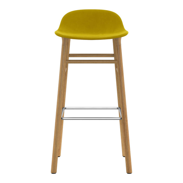 Yellow upholstered bar stool with natural wood legs and a metallic footrest, showcasing a modern, minimalist design.
