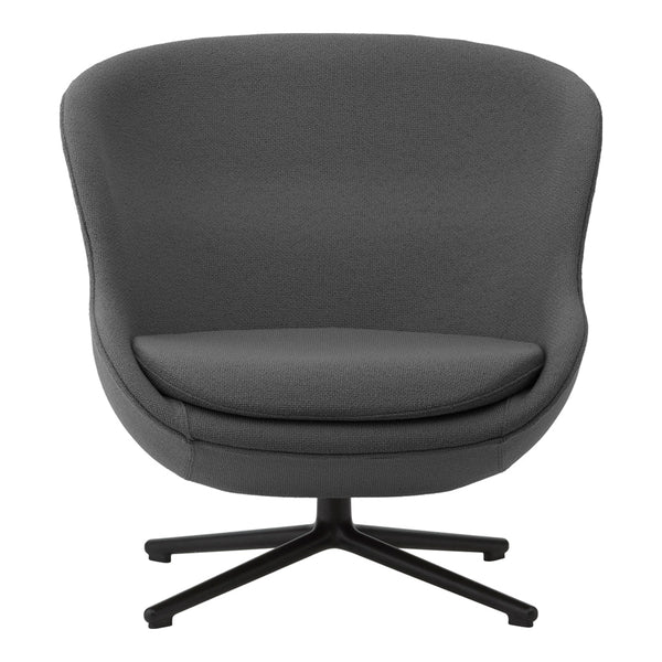 Gray upholstered chair with a smooth finish and a round, contemporary design on a sleek black metal base.