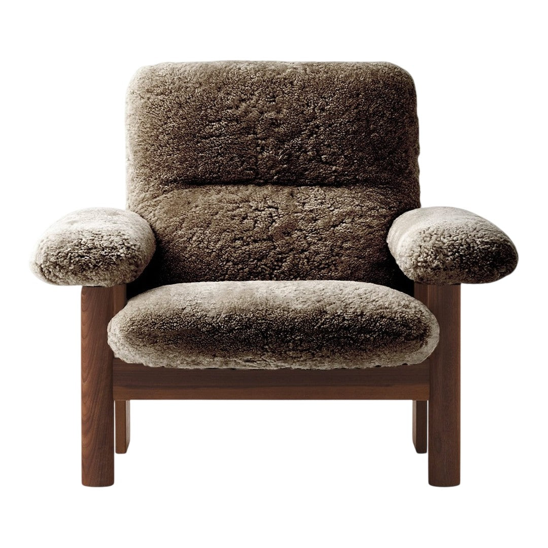 Brown plush armchair with soft, textured upholstery and minimalist wooden frame. Cozy and stylish design.