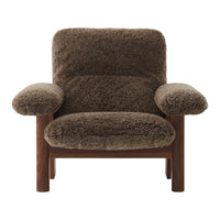 Brown textured upholstery armchair with plush, cozy surface and simple wooden frame. Perfect for modern decor.