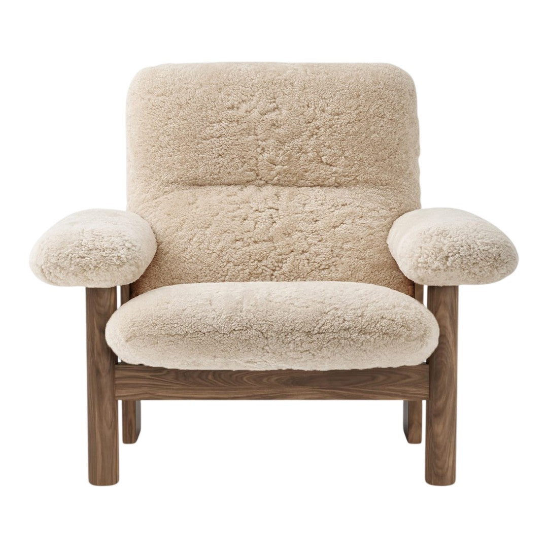 Cozy beige boucle upholstery with a smooth wooden frame, featuring a minimalist design and soft, rounded shapes.