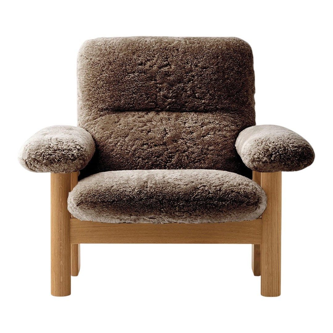 Brown upholstered armchair with a textured, cozy pattern and light wood frame. Ideal for modern decor.